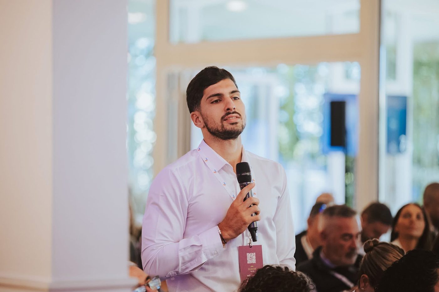 Jadon Zammit, CEO of Alphatech and host of MIGJA, asking a question at a Malta business event